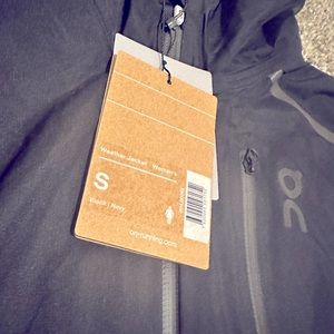 On running Women’s weather jacket size is a small navy/black Brand new with tags
